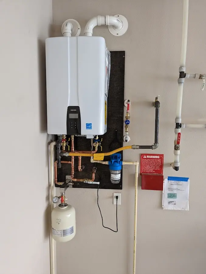 Professional plumber installing copper piping in a Gahanna home